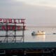 The Pike Place Market sign overlooking a boat cruising Seattle's Puget Sound.