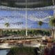 Pacific Gaylord Resort atrium with palm trees, water feature and seating area.