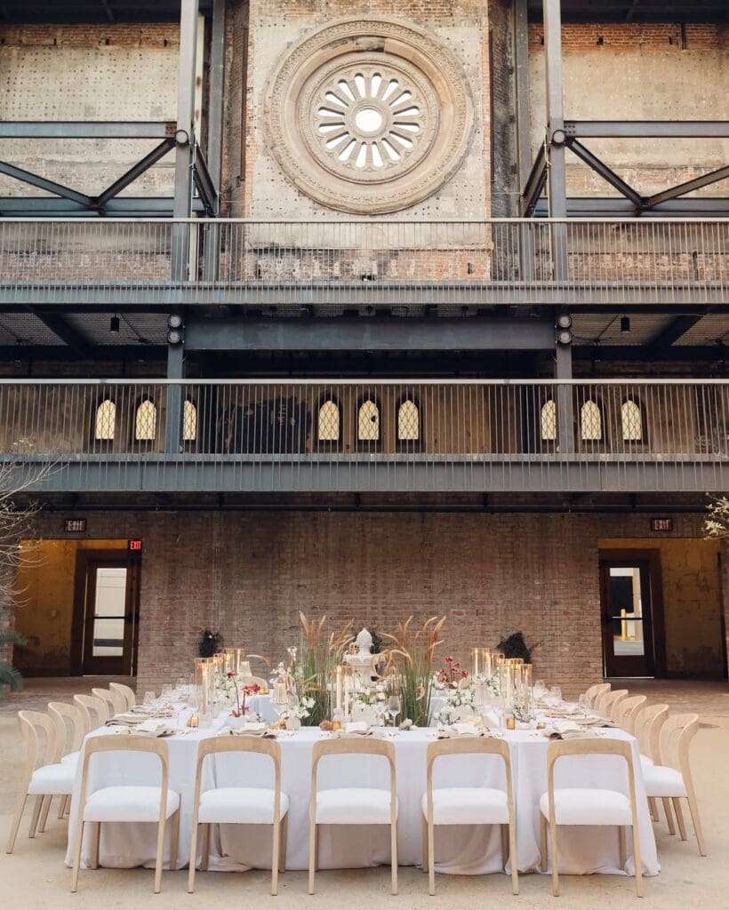 A large square table configuration sits in the center of Monroe Street Abbey in Downtown Phoenix, decorated for an outdoor dining event.