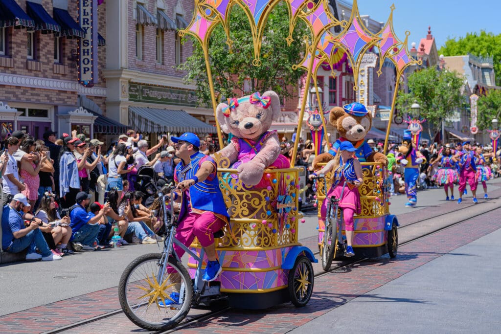 Bicycle riders escort Duffy and ShellieMay on floats during the “The Celebrate Happy Cavalcade” at Disneyland Park in Anaheim.