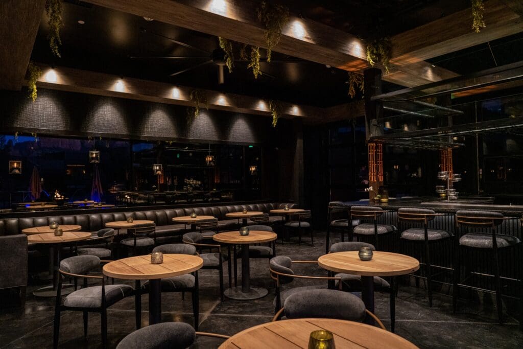 Roundtop tables, booth seating and bar seating line the interior of Ambiente's Forty 1 restaurant.