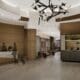 A photo rendering showing the new lobby sitting area and check-in desk at The Grand Hyatt DFW.