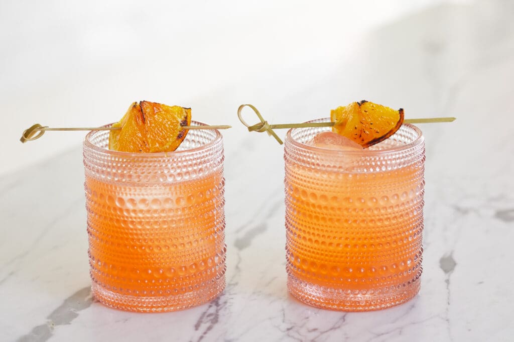 Two cocktails garnished with oranges to represent Mother's Day at The Plaza Hotel Pioneer Park.