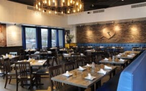 An interior photo of Patricia's Pizza in Scottsdale with booth and center tables.