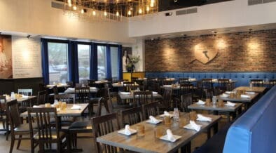 An interior photo of Patricia's Pizza in Scottsdale with booth and center tables.