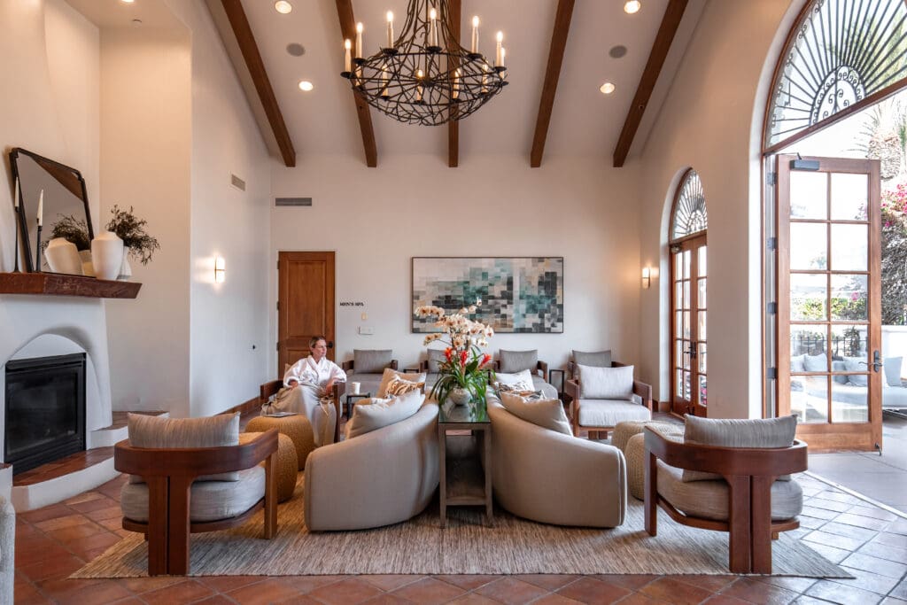A woman sits in a comfy chair in the relaxation room at The Spa La Costa.