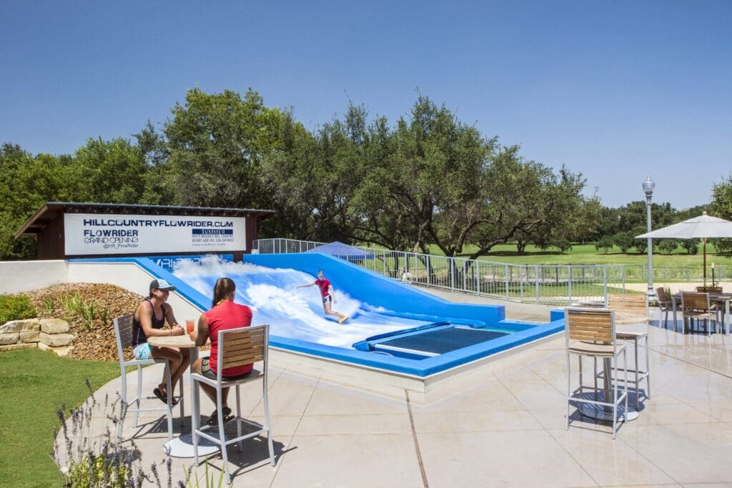 Guests ride the FlowRider Wave Simulator at Hyatt Regency Hill Country Resort and Spa.