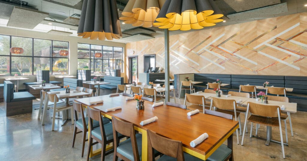 Indoor tables, chairs and booths with overhead artistic light fixtures at Hungry's in Huston