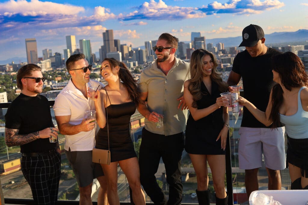 A group of young people gather on the rooftop Rose & Thorn atop the Penrose apartments in Denver's RiNo district. 