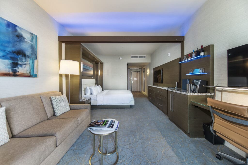 An Executive Suite at Shade at the Marina in Rodondo Beach, with king-size bed, sofa, mini bar, TV and desk.