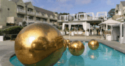 Several gold orbs float in a swimming pool at L’Auberge Del Mar for the Dolce Vita by the Sea event.