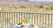 Three plates of food and two mimosa glasses on an outdoor table at CIELO at ADERO Scottsdale.