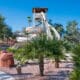 A woman walks toward the Arizona Grand Resort's Oasis Water Park Slide.