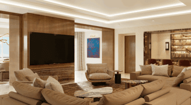 A Strip Suite living room at Green Valley Ranch Resort with family style couch, full bar, TV and views of the Vegas strip.