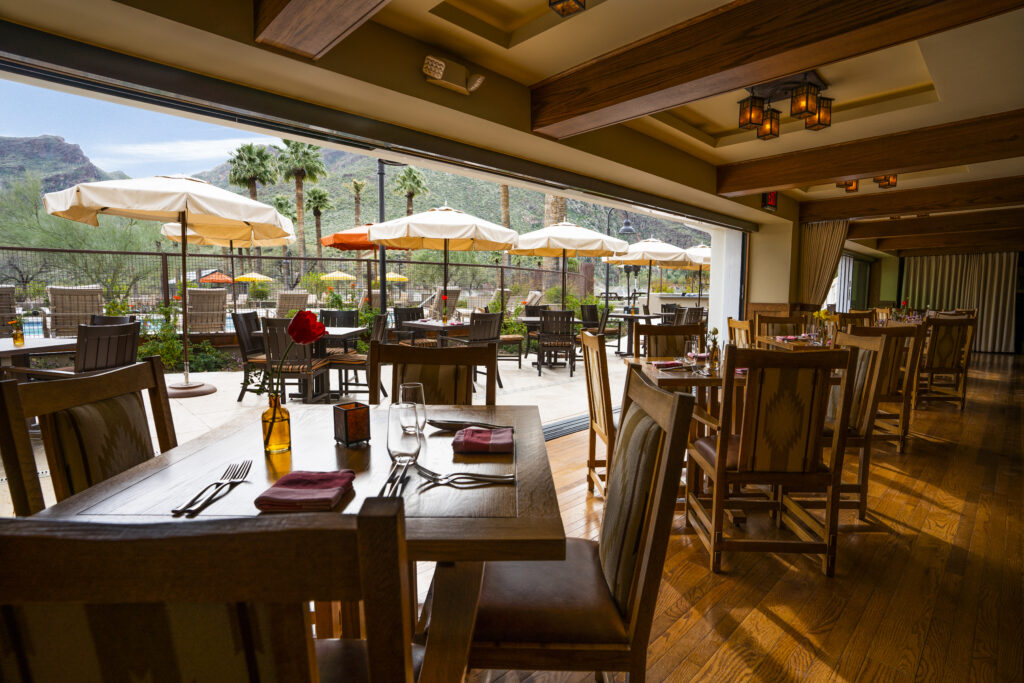 Harvest restaurant at Castle Hot Springs resort with indoor and open outdoor dining seating and beautiful mountain views.