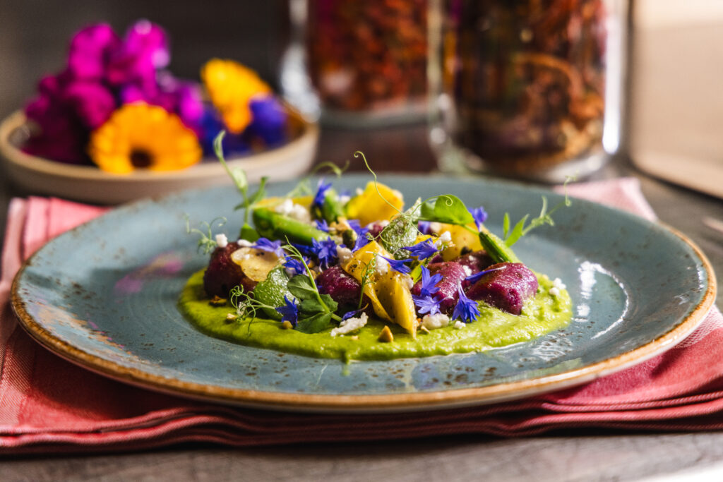 An elevated plate of gastronomic food at Castle Hot Springs atop a napkin.