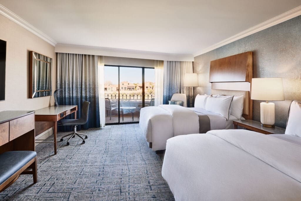 A double bed guestroom with two queen beds, desk, TV and balcony at The Westin La Paloma Resort & Spa.