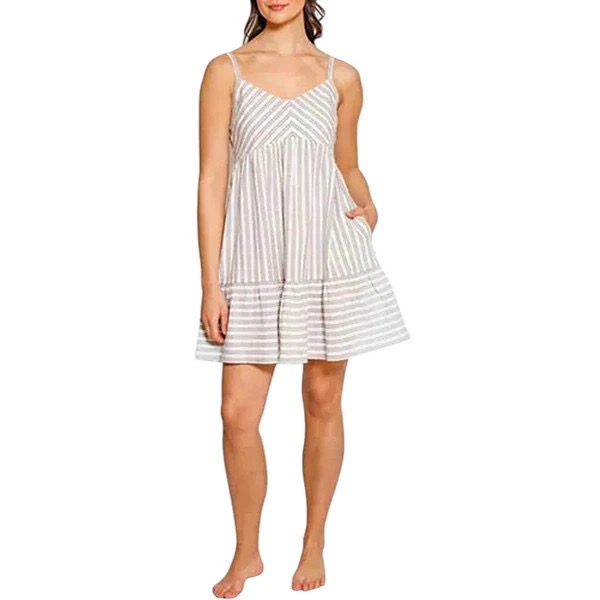A woman wears a Koy Resorts Casablanca mini dress in bold chevron stripes.