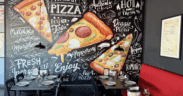 A painted mural of pizza slices at Lorenzo's Italian Kitchen.