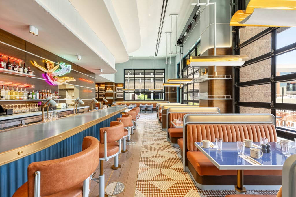 F-Sixteen restaurant at The REMI Scottsdale with bar seating, fun booths and retro decor. 