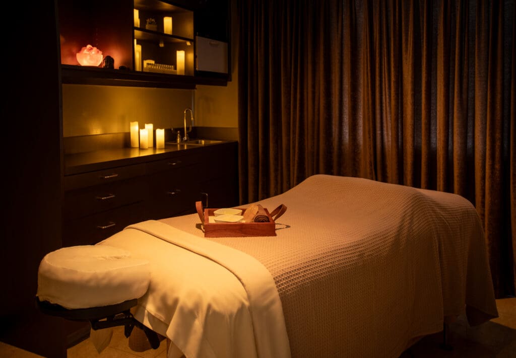 A massage table with a tray and candles on a shelf at La Paloma Spa in Tucson.