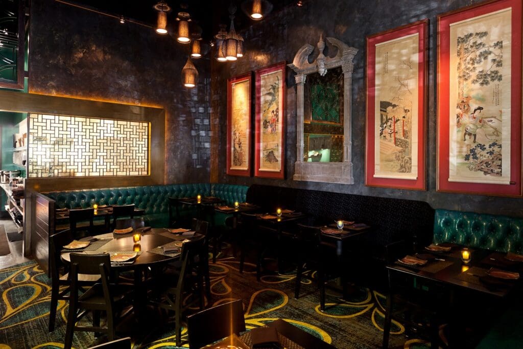 Starfish Restaurant with Asian artwork and decor, leather booth seating and candle-lit tables.
