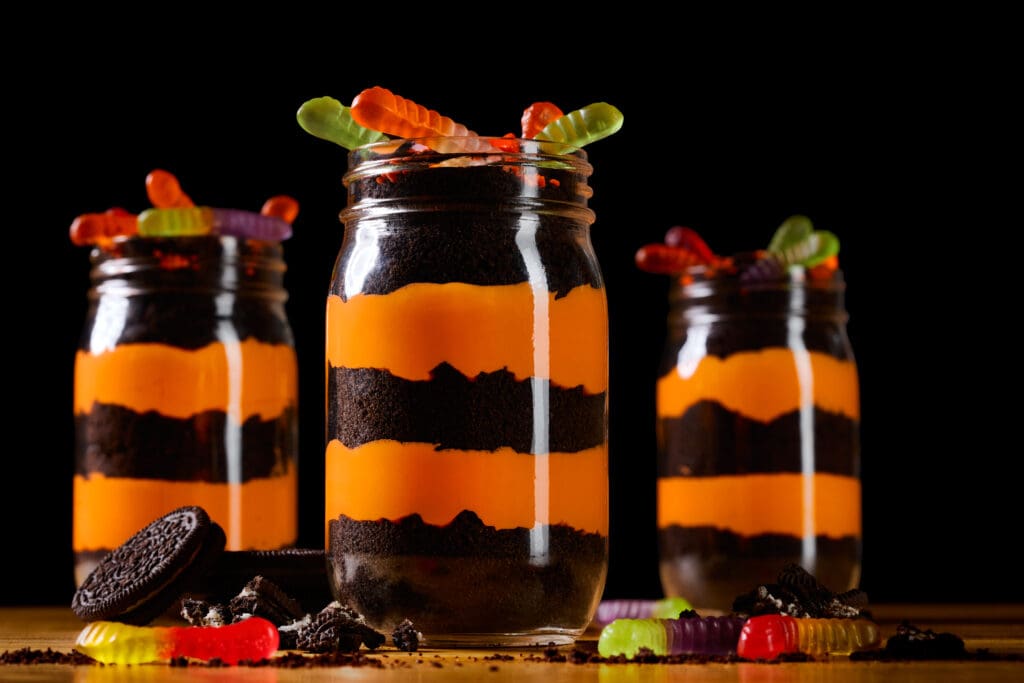 Three Great Wolf Lodge Howl-O-Ween "Worms in the Graveyard" trifle with orange pastry cream, crushed oreos and gummy worms.