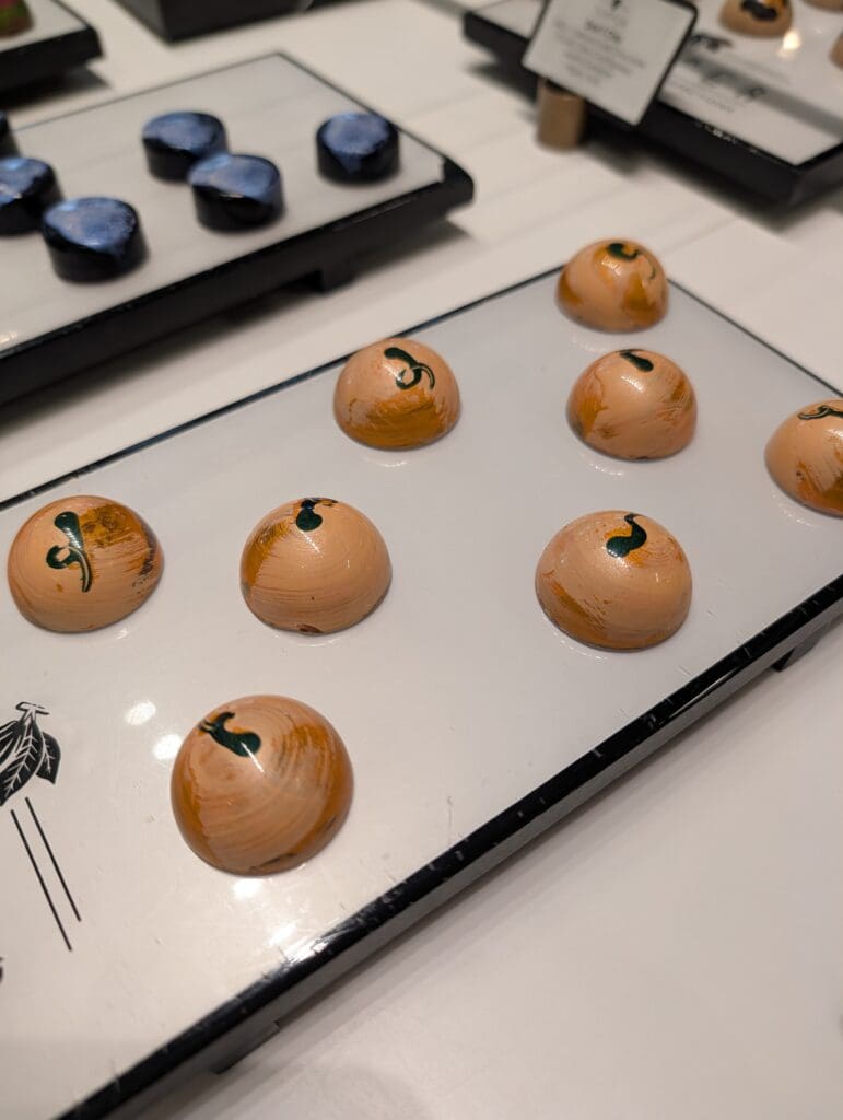 Two decorative platters with circle shaped bon bons from Temper Chocolates.