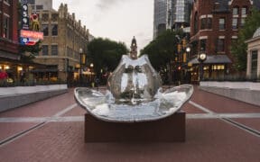 The stockyards of Fort Worth with a large silver cowboy hat installation in the center square.