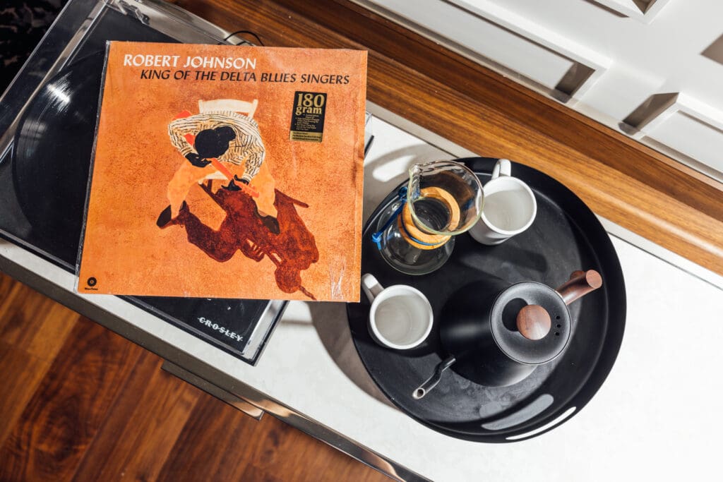 Robert Johnson's first album, "King of the Delta Blues Singers," sits atop a record player with a tea set next to it at The Gunter Hotel in San Antonio.
