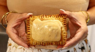 A woman holds a scratch-made pumpkin spice latte (PSL) pop tart from Moon Raccoon Baking Company.