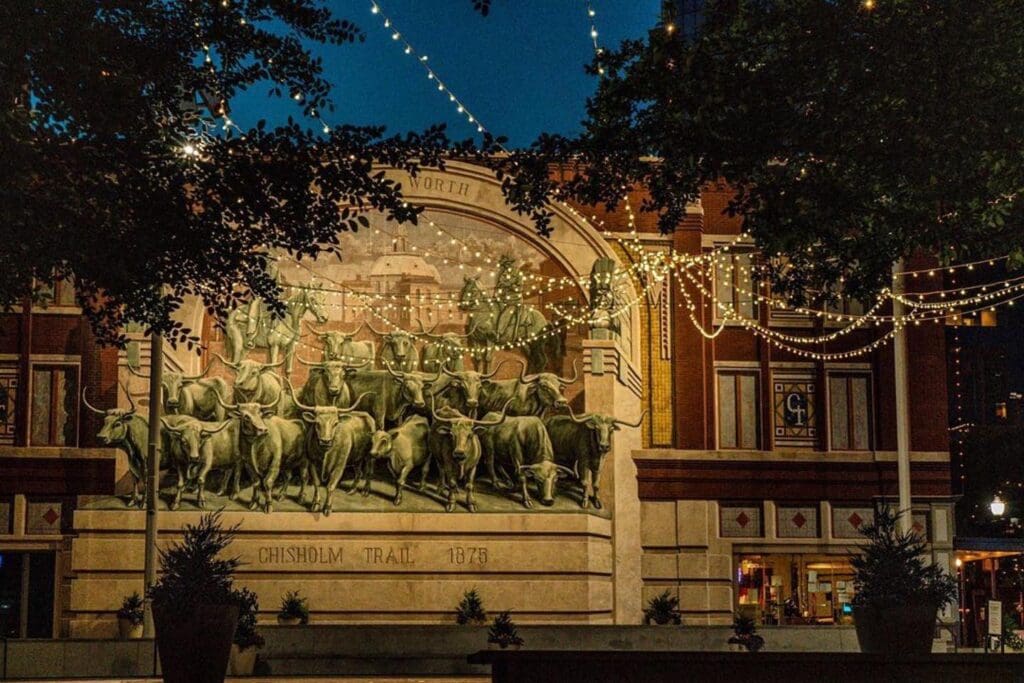 A nighttime view of the Chisholm Trail mural at Sundance Square in Forth Worth.
