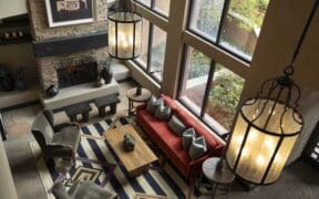 A couch, coffee table, chairs, fireplace and seating at Hotel Glorieta's lobby.