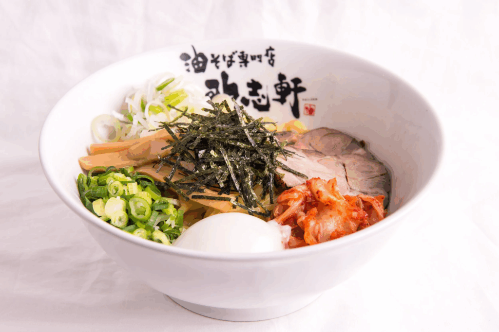 A soba bowl with soup-less ramen, meat, scallions, kimchi and egg topped with seaweed at Kajiken
