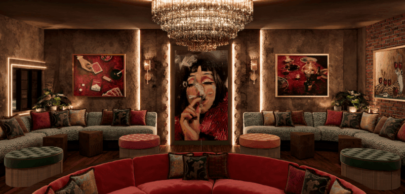 A velvet red circular couch below a stunning chandelier with forest green velvet half circle couches and Mexican-inspired decor at Pablo's Downtown Phoenix.
