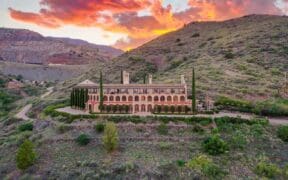 The Little Daisy hotel and venue in Jerome on a hilltop during sunset.