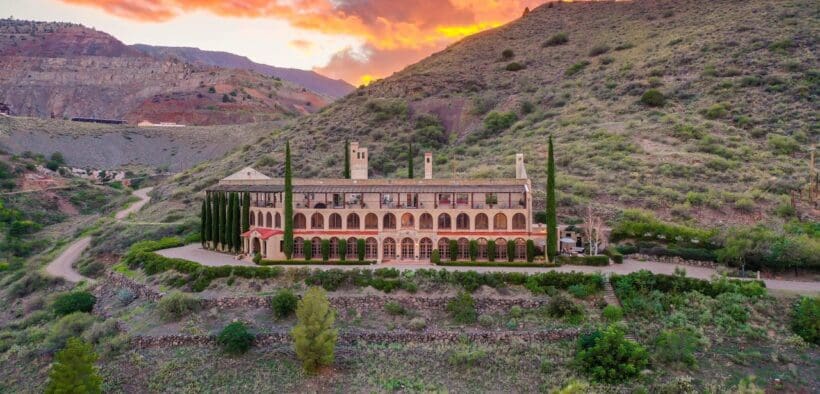 The Little Daisy hotel and venue in Jerome on a hilltop during sunset.