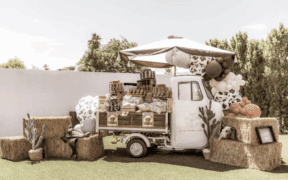 Fiore Della Vita's vintage truck, "Angela" surrounded by haystacks, balloons, crates and other event decor.