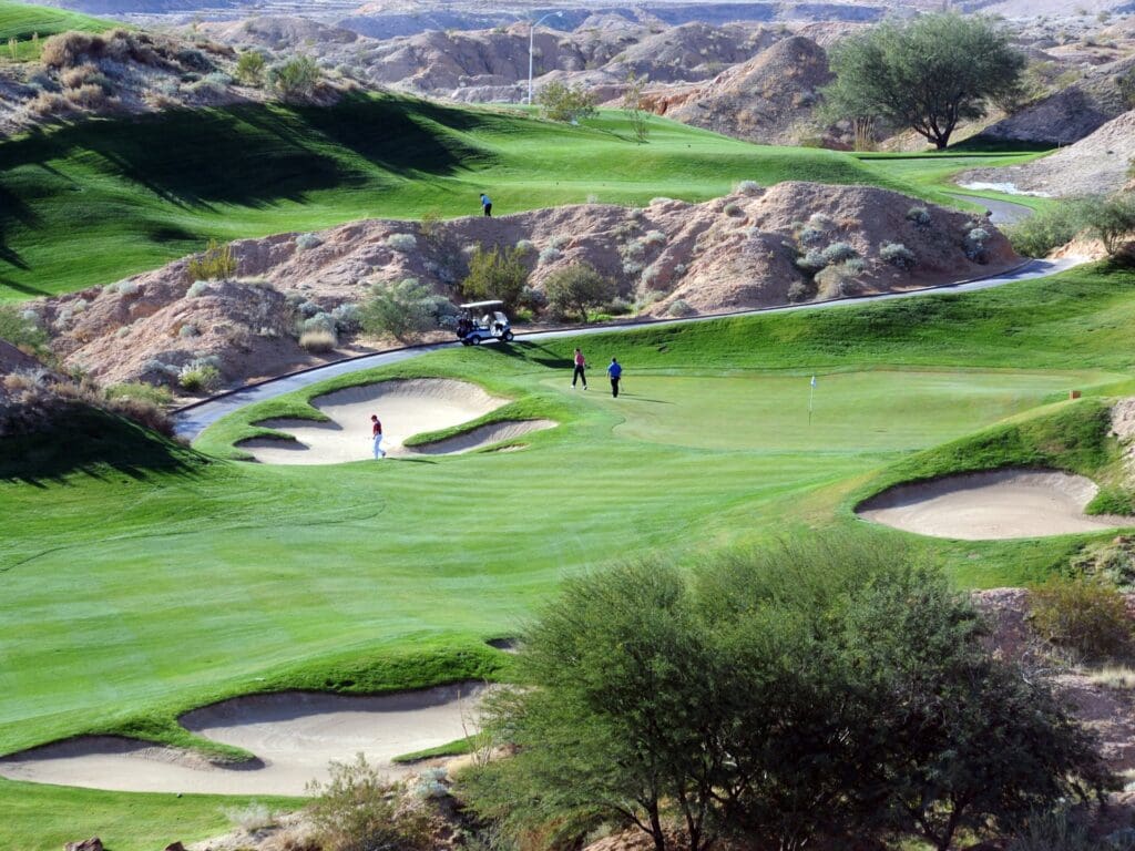 A group of golfers with a golf cart on the Wolf Creek Golf Resort golf course in Mesquite, Nevada.
