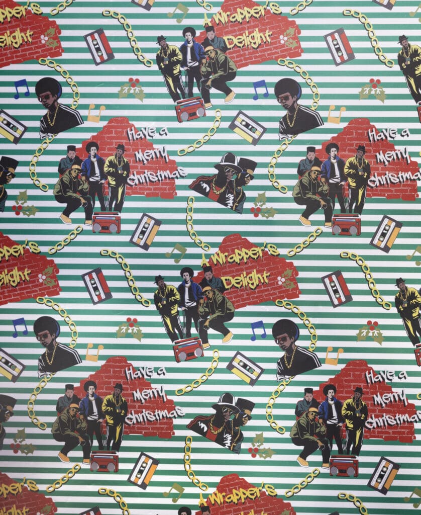 Black Paper Party's "Wrappers Delight" 2025 holiday wrapping collection with rappers, gold chains, holly leaves, tape cassettes and boom boxes.