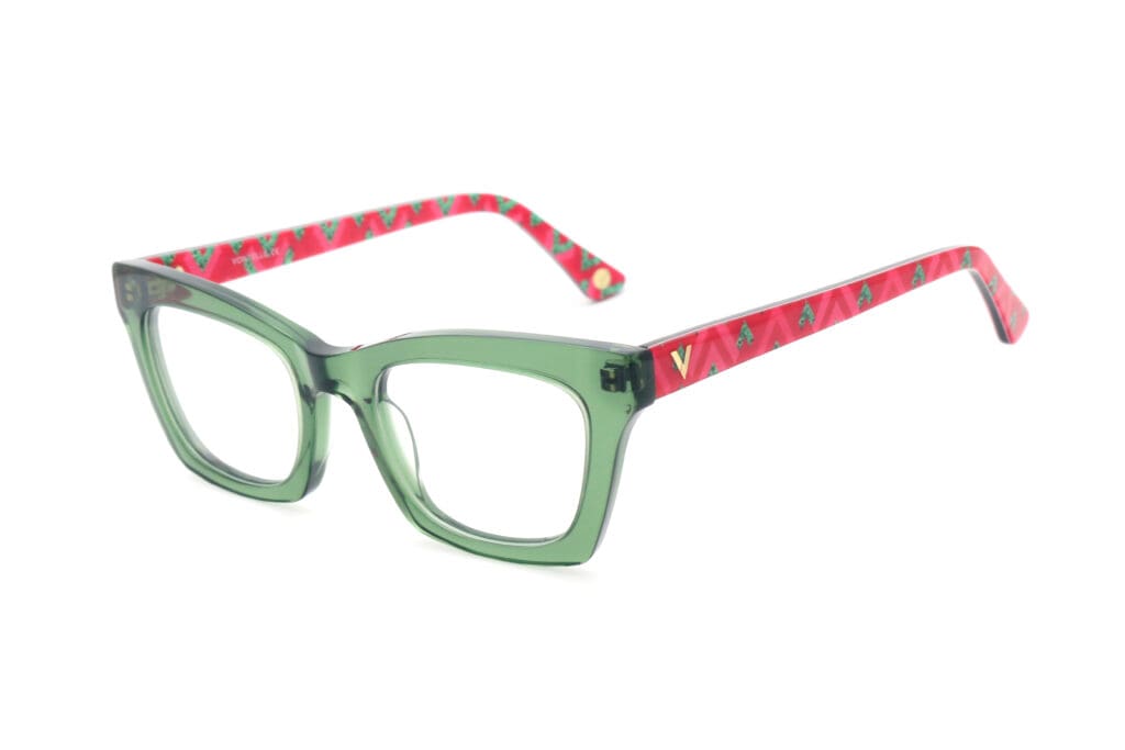 Vontélle luxury eyewear with transparent light green frames and pink-green triangle pattern on folding sides.