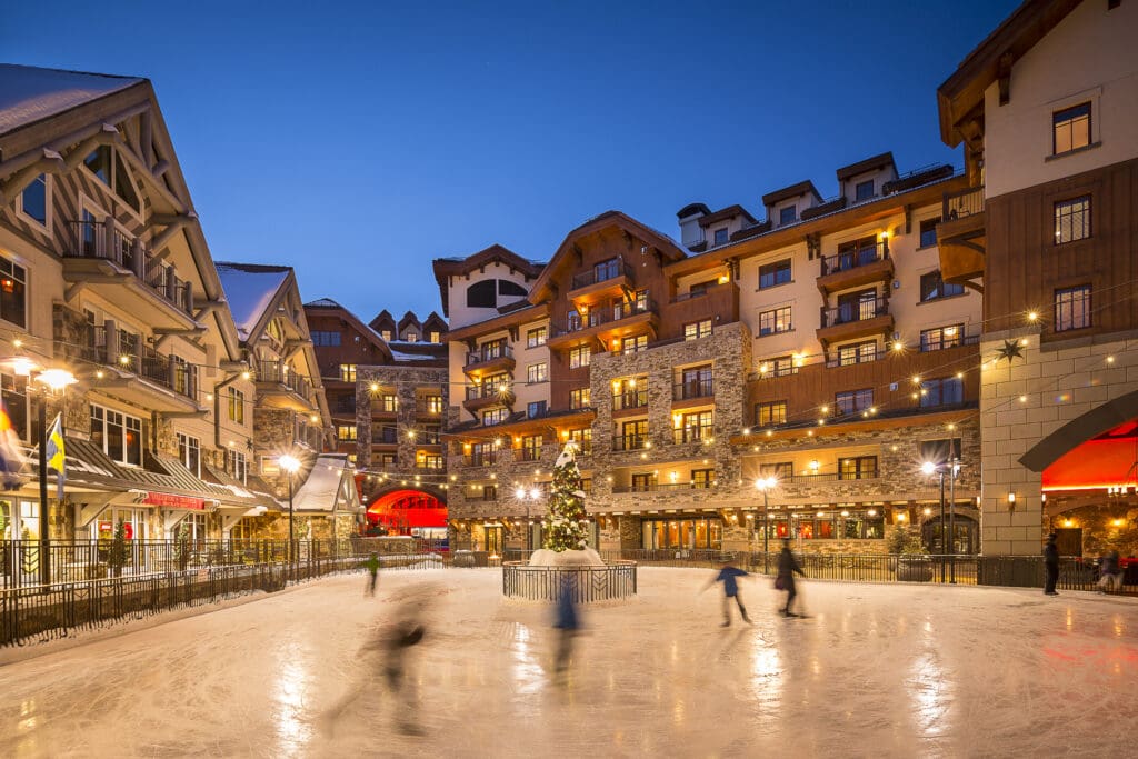 Ice skaters skate on a rink in the center of Madeline Hotel & Residences, Auberge Resorts Collection in Telluride, Colorado.