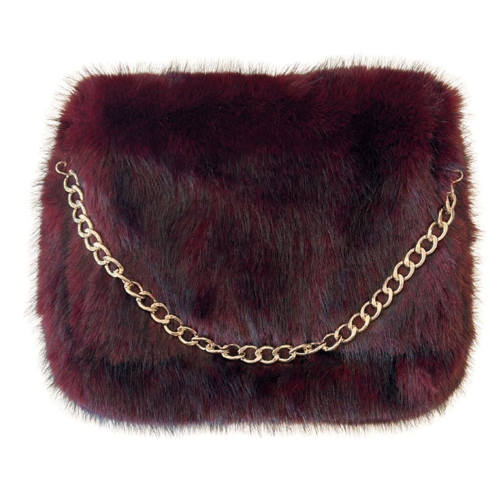 The burgundy, fluffy Arlo Bag with a gold chain from Lindsay Nicholas New York.