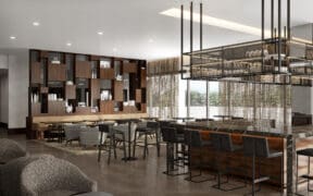 The bar and lobby of the AC Hotel by Marriott in Old Town Scottsdale, with bar seating and comfortable chairs.