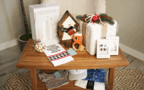 A SmartMouth dental gift set, The Collective, a baby rattle and onsie and other products from Chandler Fashion Center on a table.