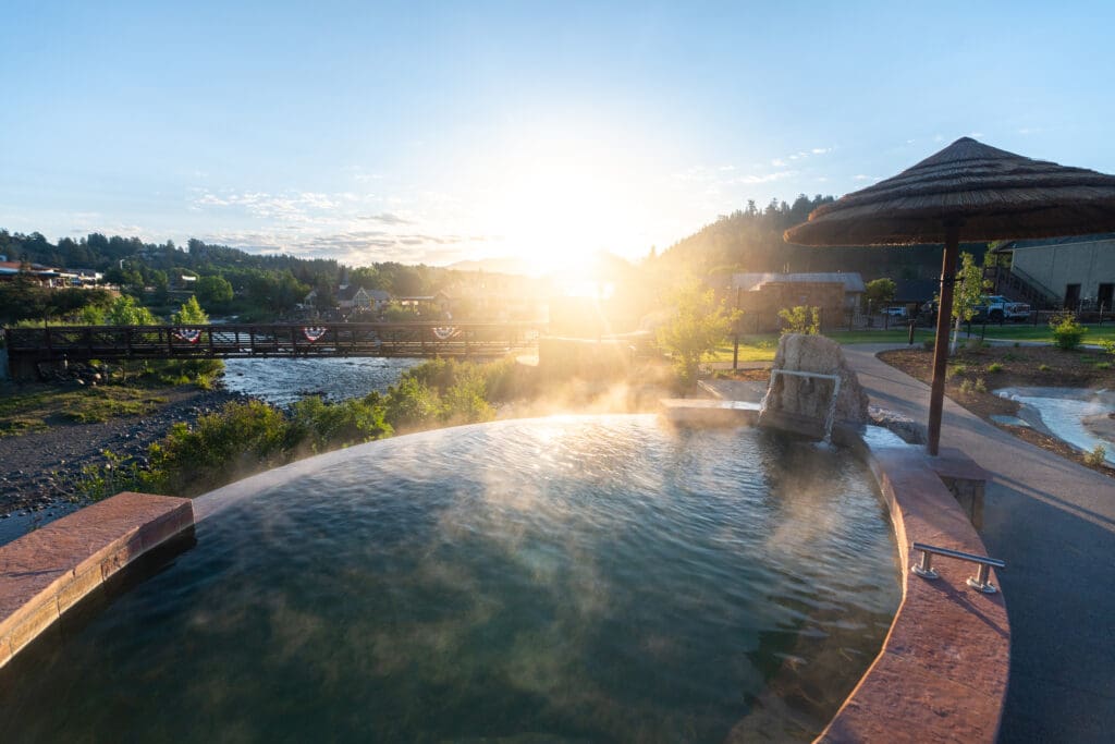 Steam rises from one of the geothermal pools overlooking the San Juan River and bridge at The Springs Resort in Pagosa Springs.