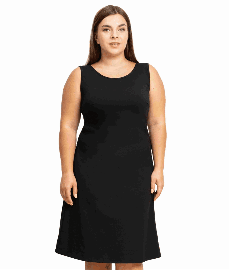 A plus-size model wears a black Exclusively Kristen athleisure dress. 