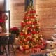 Two decorated Christmas trees with presents underneath at Culinary Drop Out in Phoenix.