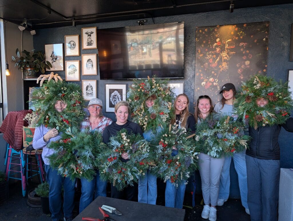 The staff at Dark Sky Brewing Co. in Flagstaff hold wreaths.