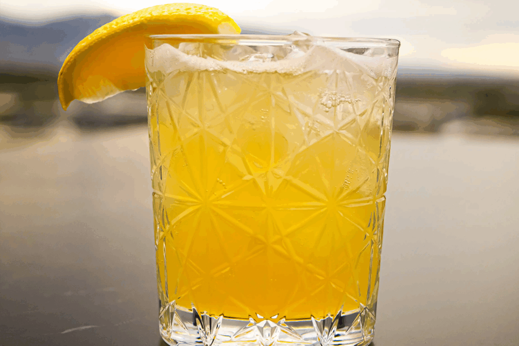 The Honey Badger Redux N/A beverage at Van Ryder rooftop restaurant with lemon wedge garnish.